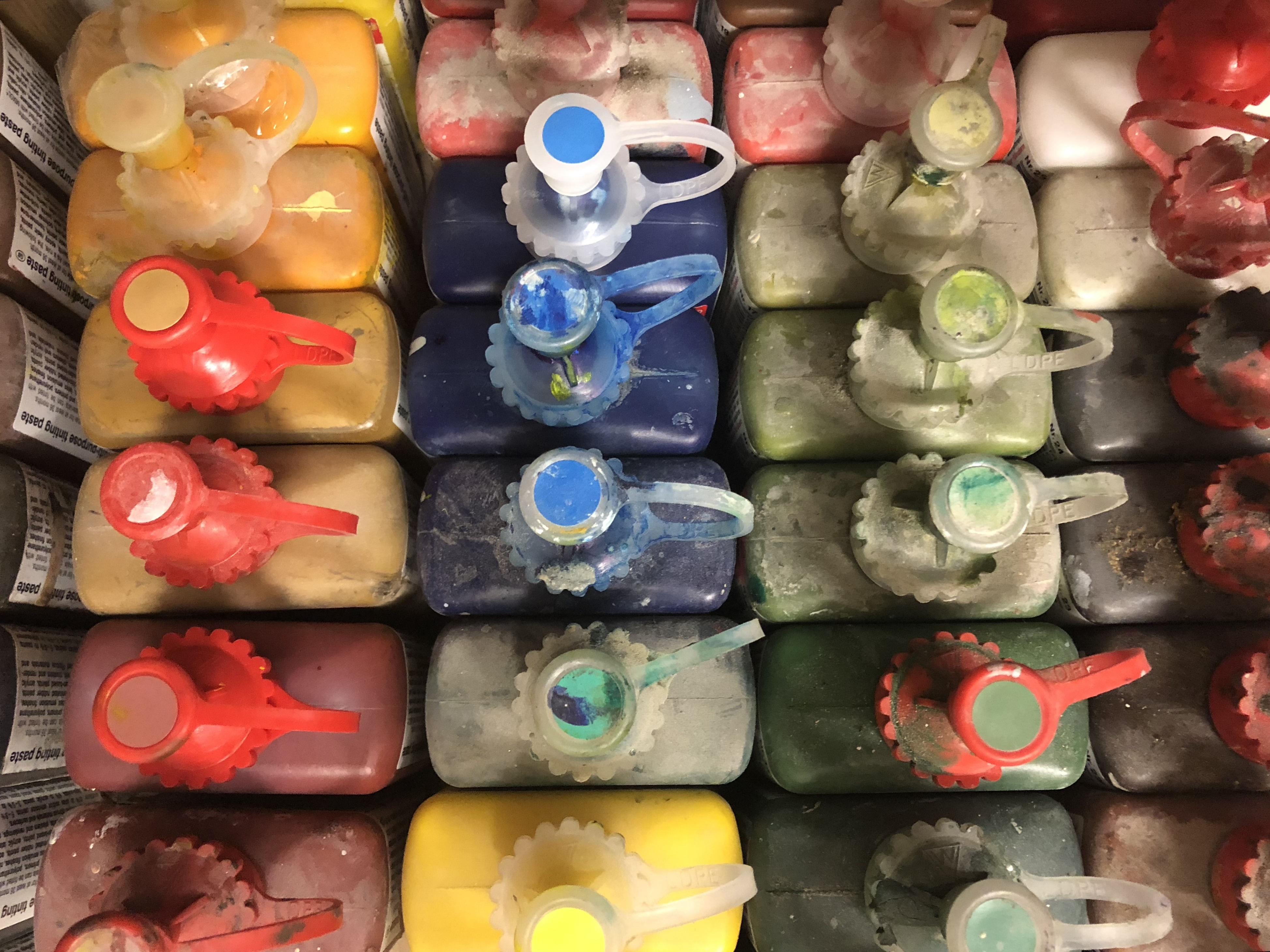 Coloured pigment bottles in the workshop